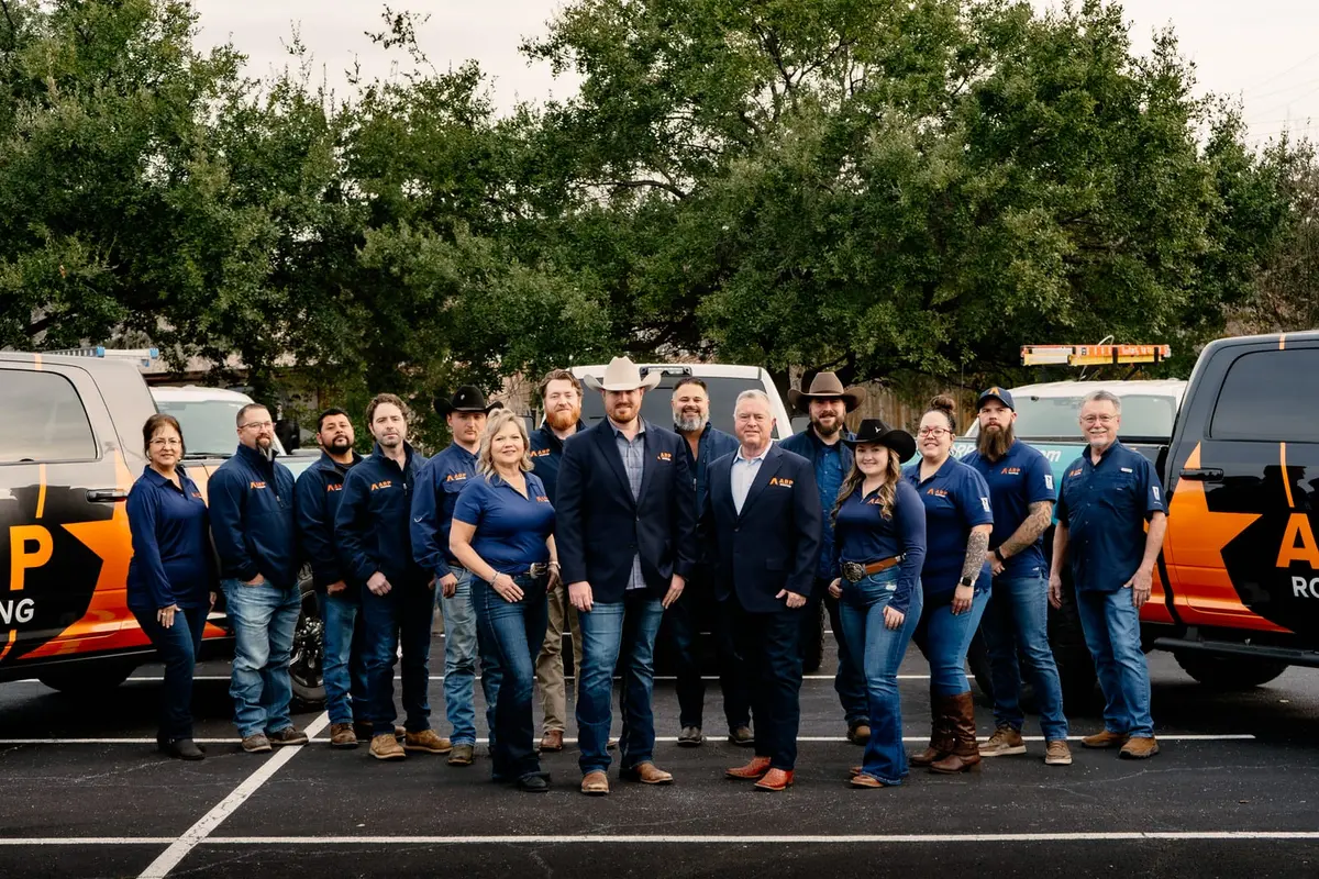 The ARP Roofing & Remodeling team in front of the company vehicles