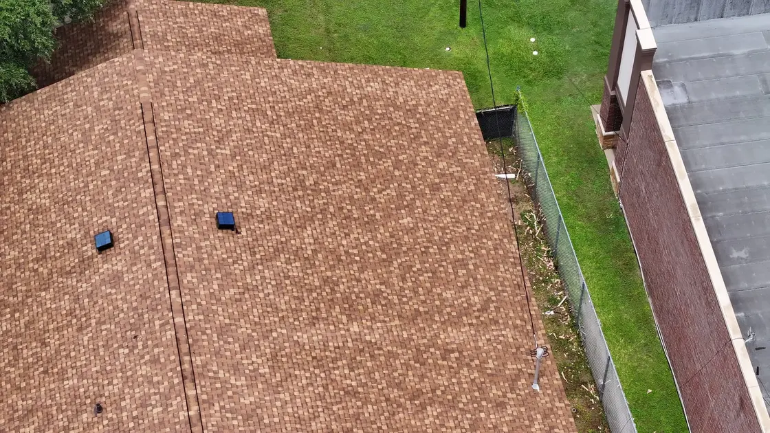 Aerial view of roof-mounted exhaust vents on a Texas asphalt shingle roof