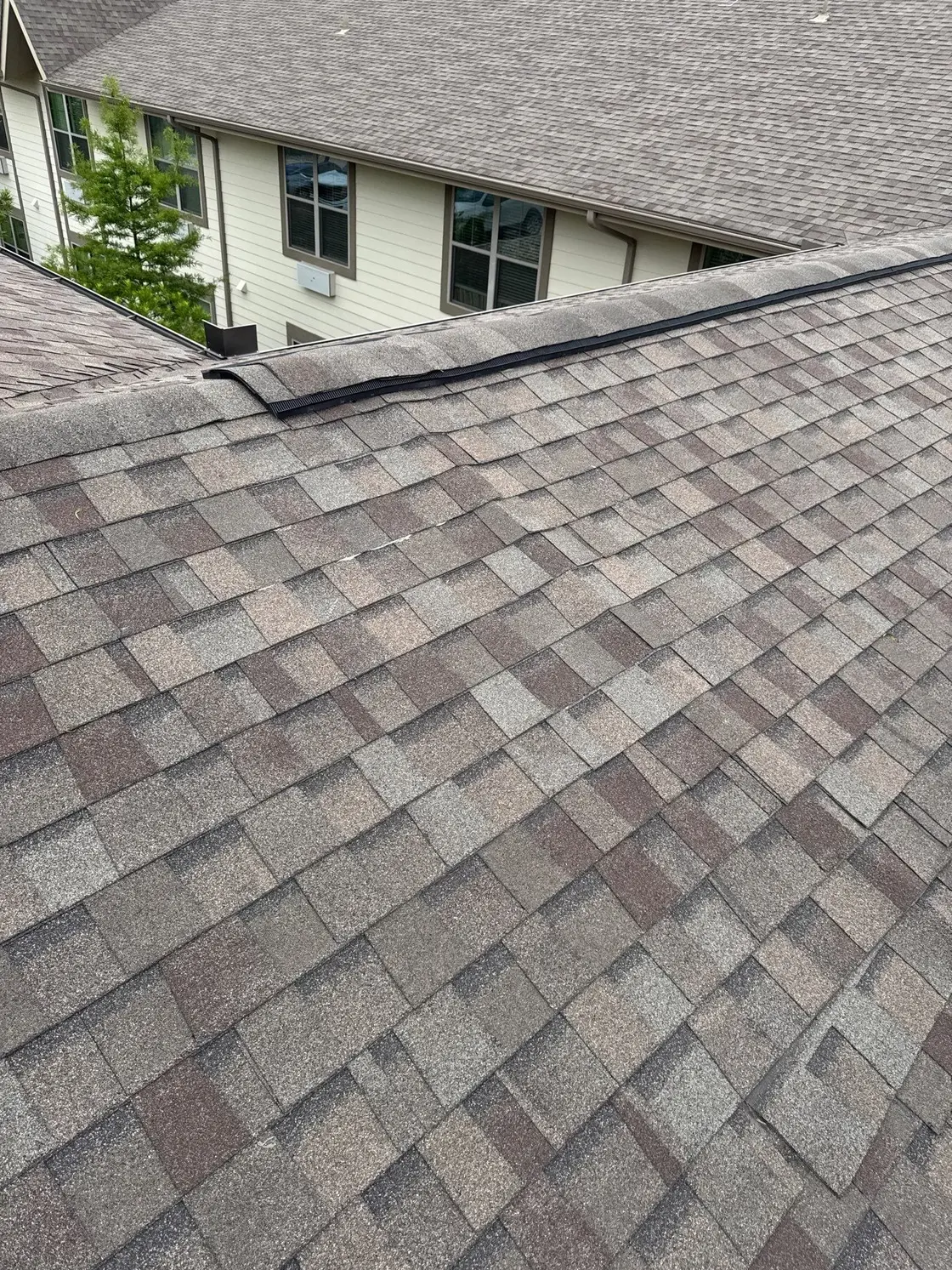 Valley flashing detail where two asphalt shingle roof slopes meet on a Texas home