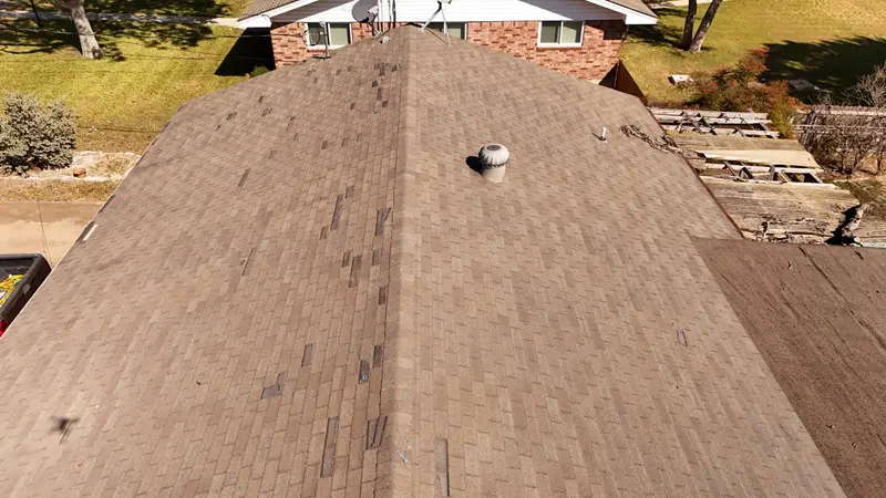 Wind-displaced shingle tabs scattered across a whole roof field — every gap is a future leak on the Coastal Bend, which is why we document the entire roof before quoting.