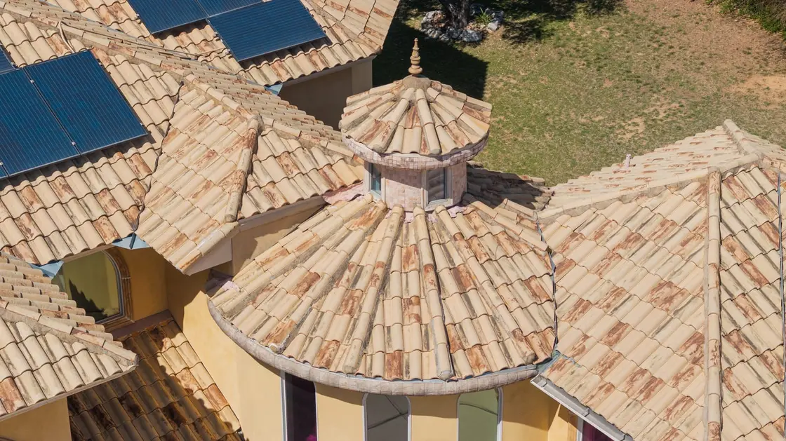 Barrel tile roof on a residential home with a cupola