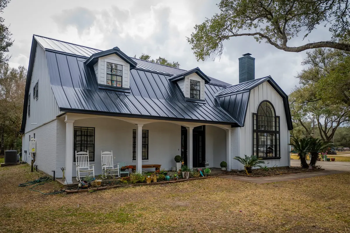 Black standing seam metal roofs on modern, farmhouse, and brick Texas homes