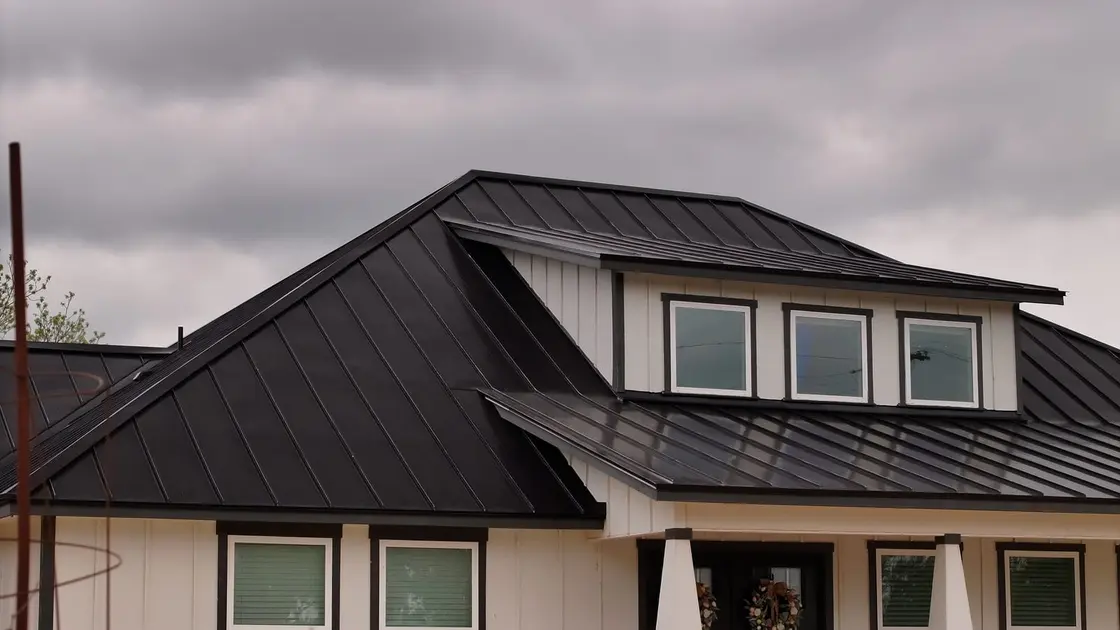 A modern Texas home with a black standing seam metal roof
