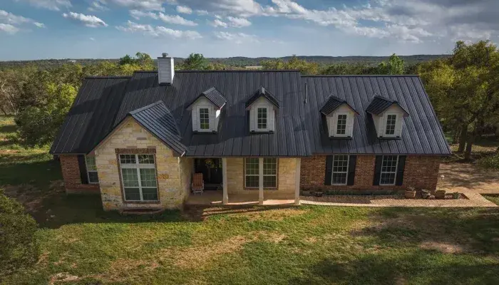 Black standing seam metal roofs on modern, farmhouse, and brick Texas homes