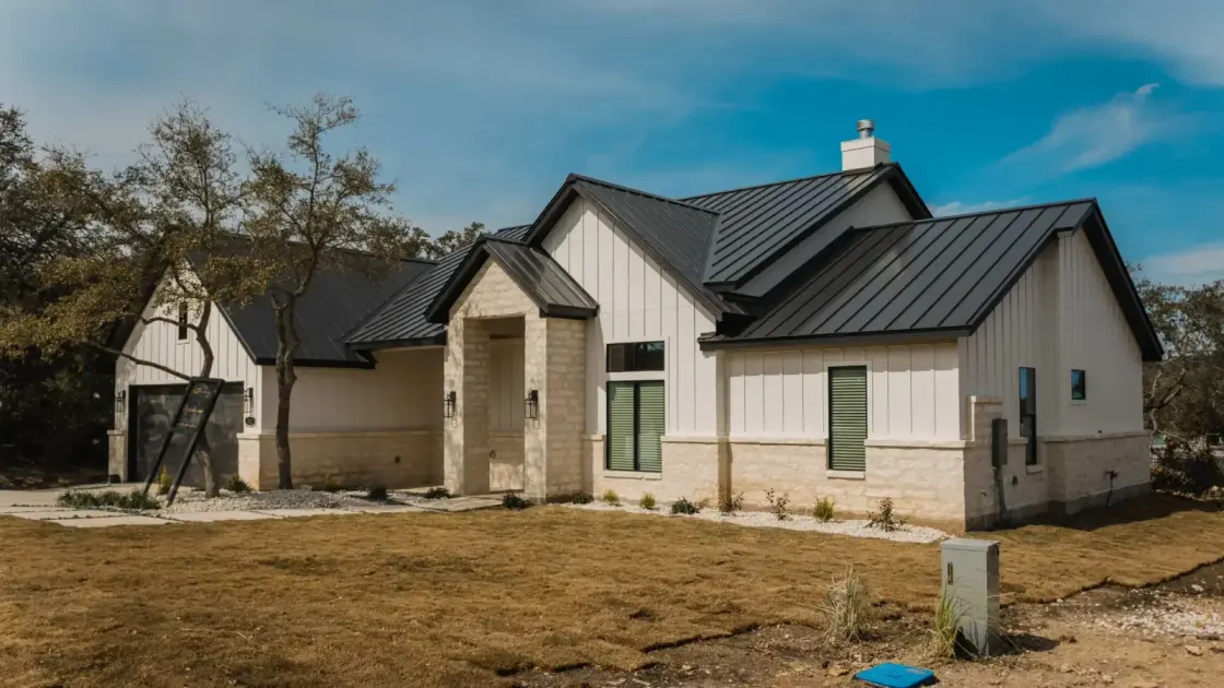A metal roof with a rich painted finish on a home in the Texas Hill Country