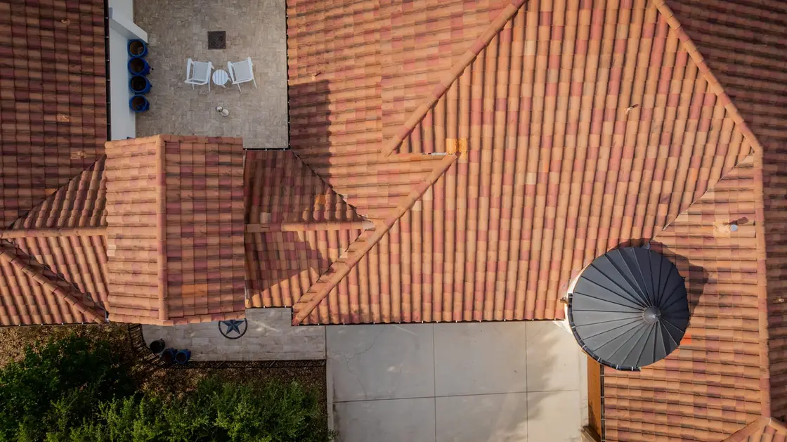 Aerial view of a multi-peak clay tile roof with several valleys