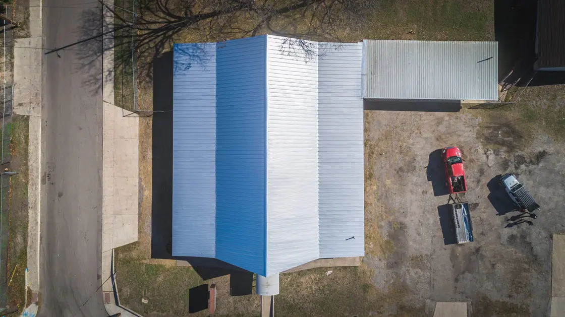 Aerial view of an exposed-fastener corrugated metal roof on a Texas commercial building