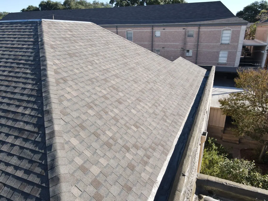 Gray low-slope asphalt roof of the built-up and modified-bitumen type these repairs cover
