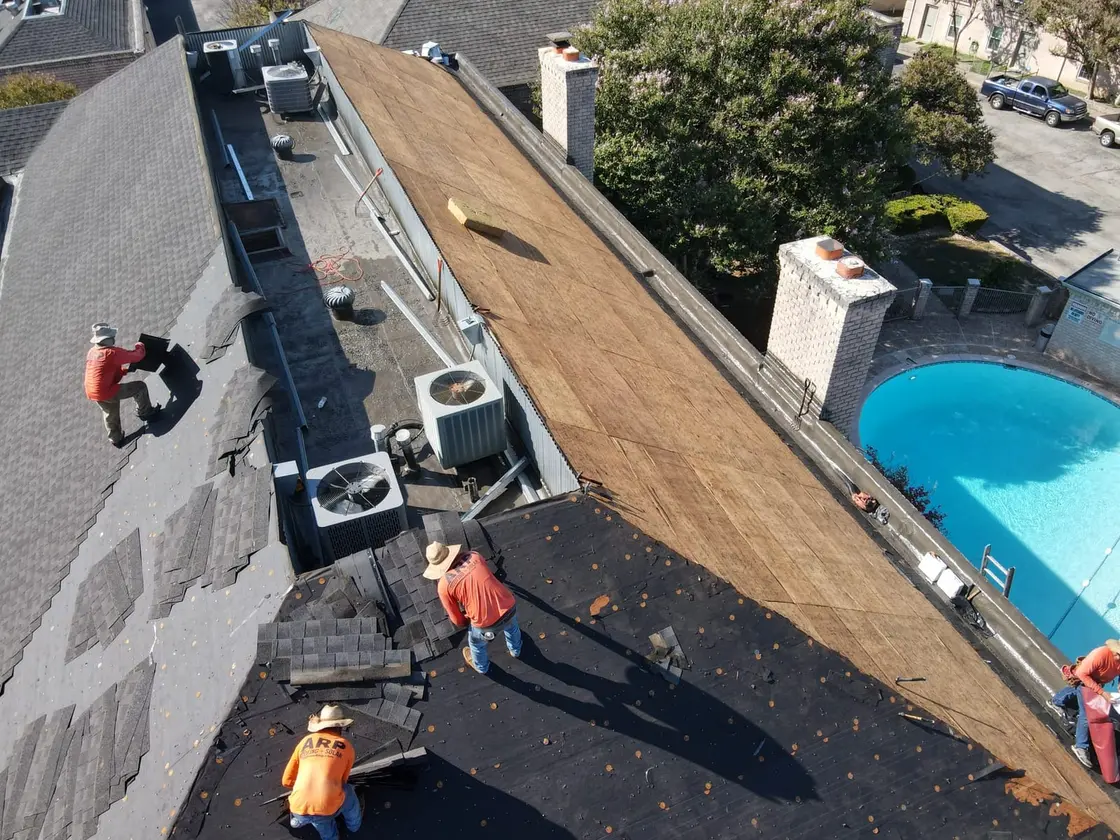 ARP-supervised crew installing a low-slope commercial roof replacement to manufacturer specification in Texas