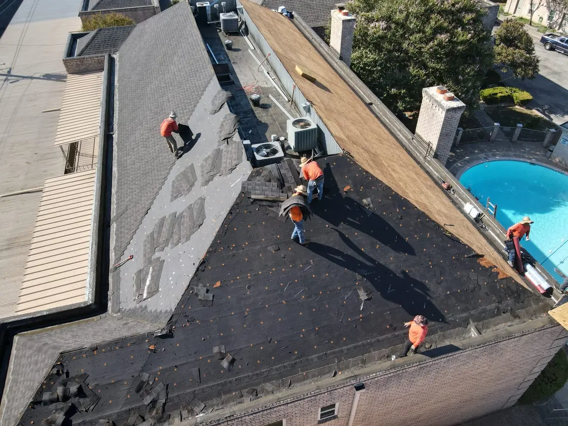 ARP-supervised crew installing a low-slope commercial roof replacement to manufacturer specification in Texas
