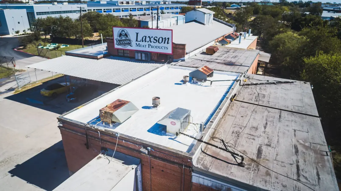Rooftop HVAC equipment and curbs on a commercial TPO flat roof