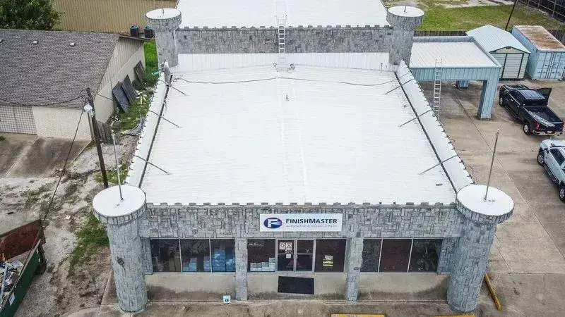 Roof-edge and parapet drainage on an Austin commercial building — sized and detailed to carry a Central Texas downpour off the roof, not pond on it.