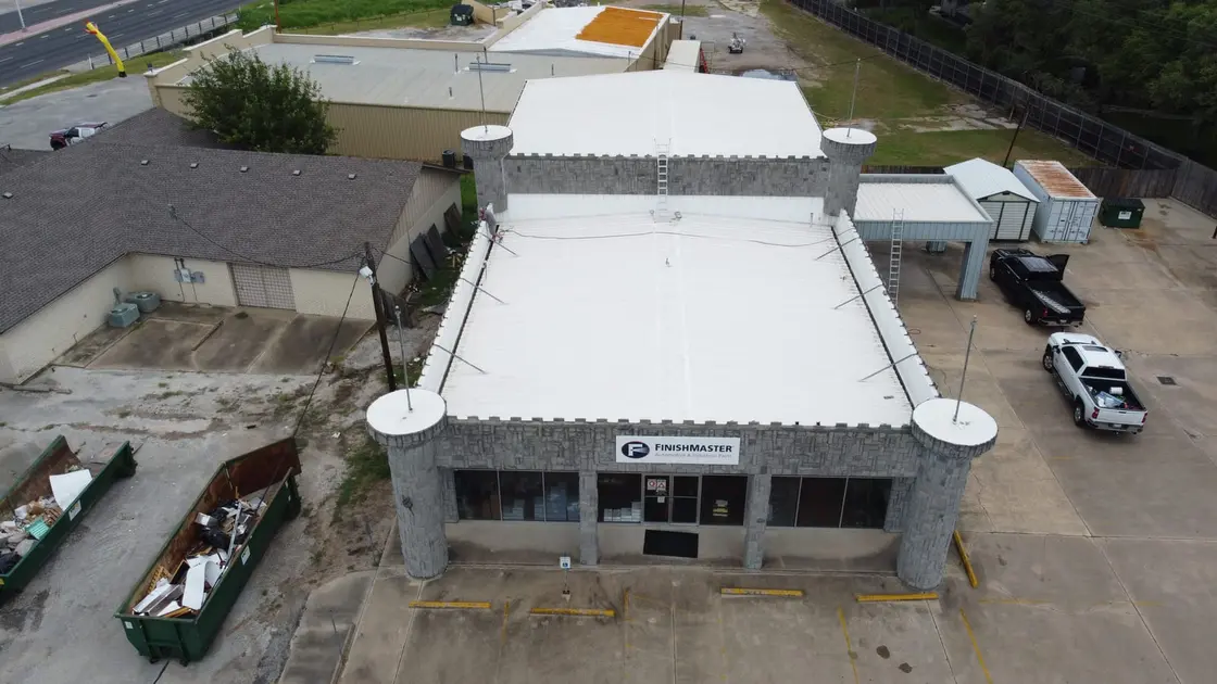 Finished white reflective roof surface across a large industrial low-slope building