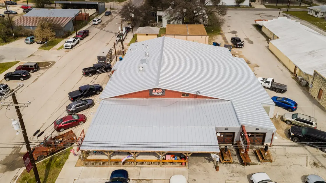 Exposed-fastener corrugated metal roof on a Texas commercial warehouse