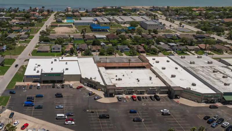 A completed commercial roof coating on an Austin building — the reflective, seamless field a restoration leaves behind, no tear-off.
