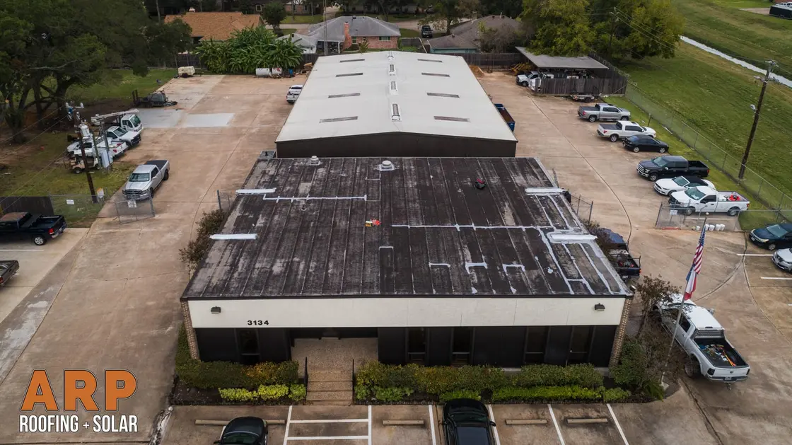 Large low-slope warehouse roof recovered with a seamless membrane across the field