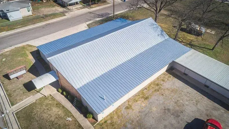 Standing-seam metal panels on a low-slope San Antonio commercial roof