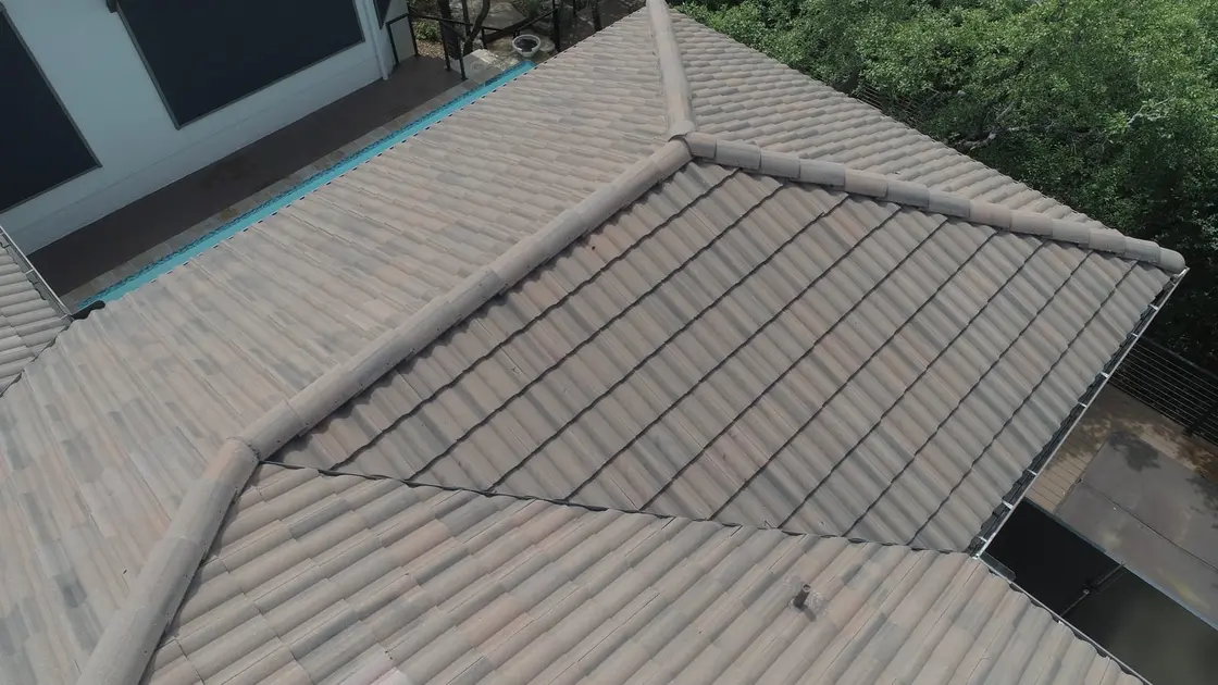 Standing seam metal panels being installed on a residential roof
