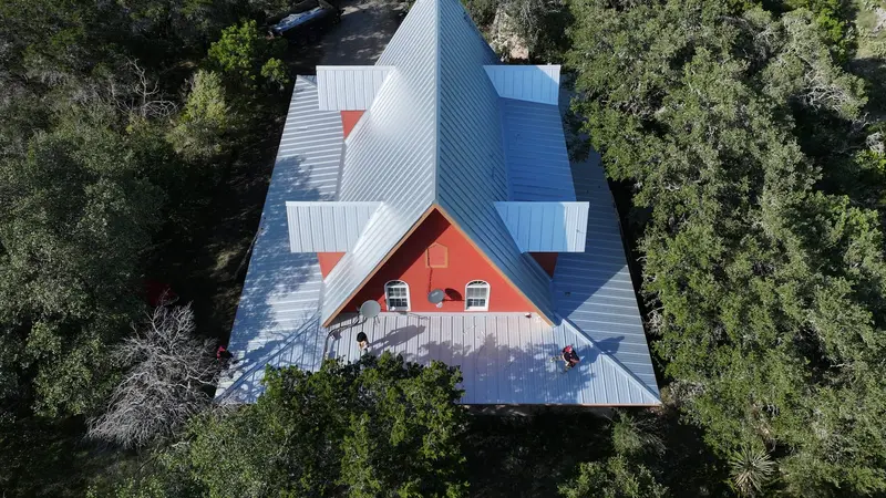 A factory PVDF color finish on standing seam — color and profile move the price as much as the panel gauge.