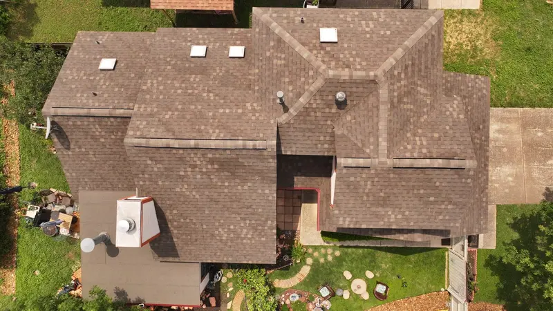 A brown architectural-shingle reroof from above — the same install standard on every Victoria home, whatever color you choose.