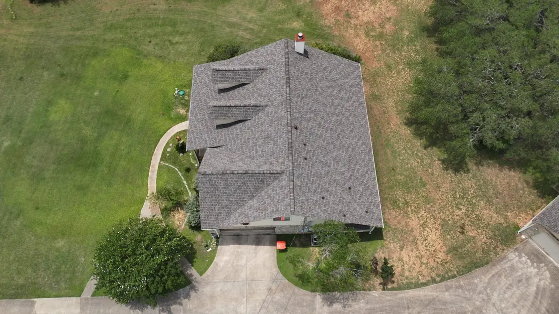 Flat, uniform 3-tab asphalt shingle roof on a Texas home seen from above