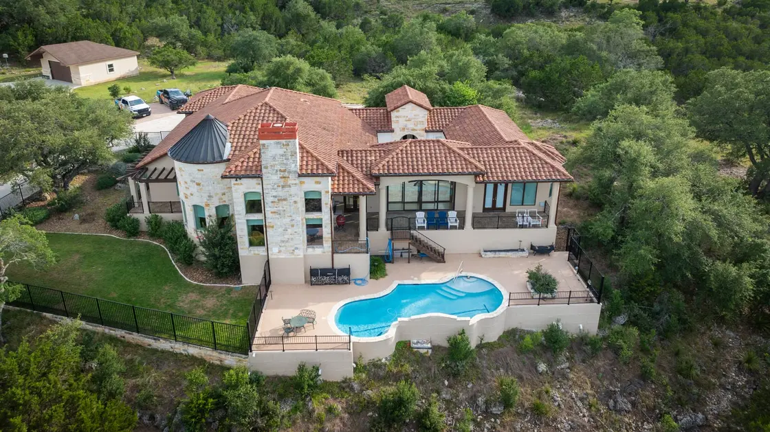 A red clay barrel-tile roof on a Texas Hill Country home