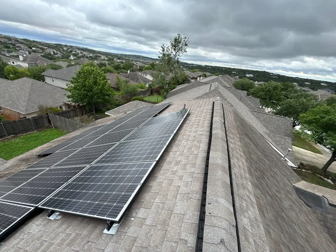 Solar panels mounted on an asphalt shingle roof showing the roof-mount penetrations