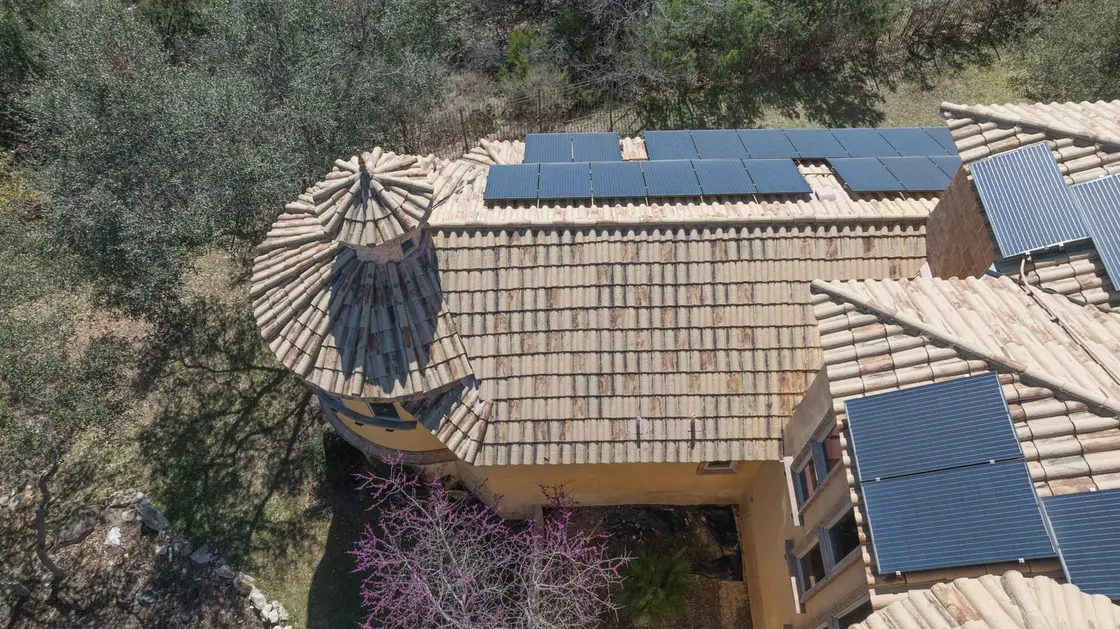 Aerial view of a Spanish tile roof with solar panels